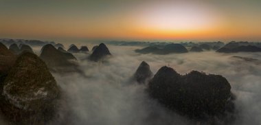 Sunrise and sea of clouds at the Dongtang Karst Peak Cluster in Libo County, Guizhou, China