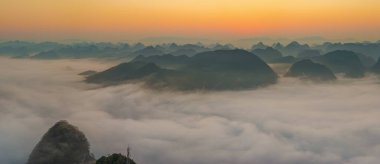 Sunrise and sea of clouds at the Dongtang Karst Peak Cluster in Libo County, Guizhou, China