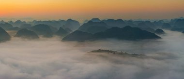 Sunrise and sea of clouds at the Dongtang Karst Peak Cluster in Libo County, Guizhou, China