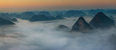 Sunrise and sea of clouds at the Dongtang Karst Peak Cluster in Libo County, Guizhou, China