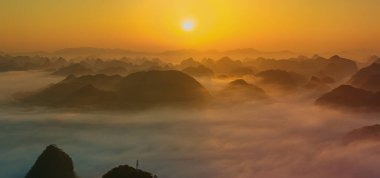 Sunrise and sea of clouds at the Dongtang Karst Peak Cluster in Libo County, Guizhou, China
