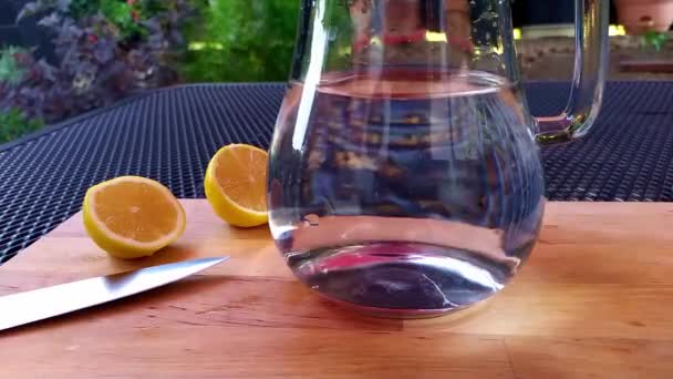 Close View Glass Jug Which Pure Water Poured Background Pieces — Stock Video