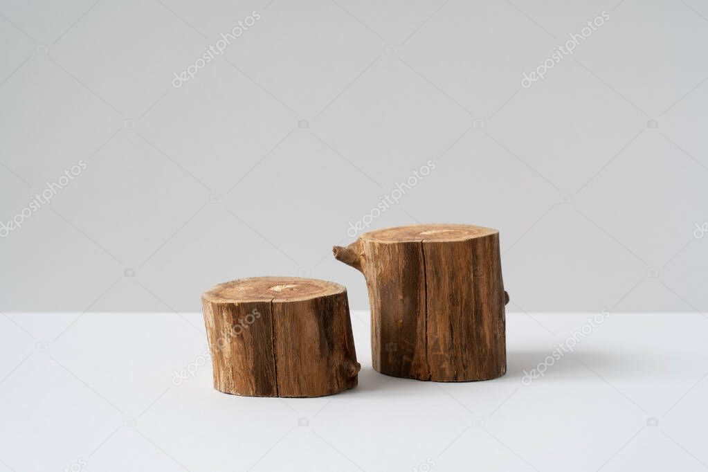 Two empty round wooden podium for product presentation on grey background. Natural materials mockup for cosmetic advertising. Eco concept