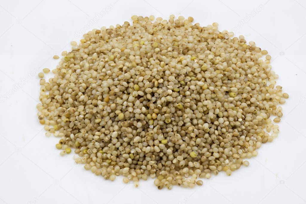 Close up of little millet grains against a white background, isolated