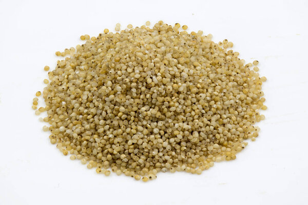 Close-up of barnyard millet grains on an isolated white background