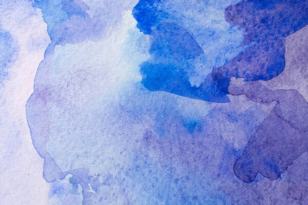 Abstract Hand painted blue purple watercolor background on wet paper, texture for creative wallpaper or design artwork.