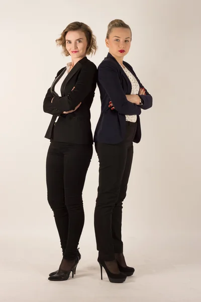 Two business women in black suits — Stock Photo, Image