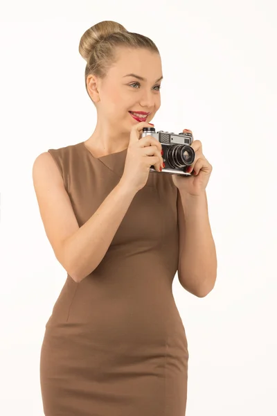 Girl with a camera on a white background — Stock Photo, Image