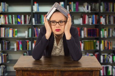 Genç kıza bir kitaplığındaki kitap okuma