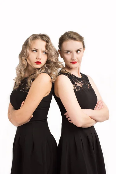 Two women in identical dresses are angry at each other