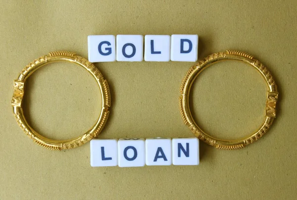 Gold loan concept depiction through jewelry and plastic blocks
