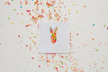 Paskalya tavşanının şeker parçacıkları üzerine oyulmuş kağıt figürü arka plan, pasta ve fırın için dekorasyon. Bahar, Paskalya konsepti. Düz yatıyordu. Yatay resim