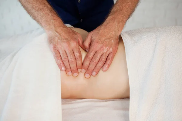 Hands of doctor masseur chiropractor pushing on back points and making acupressure treatment for woman patient in medical clinic. Beauty treatment, massage bodycare in medical clinic from professional doctor masseur concept