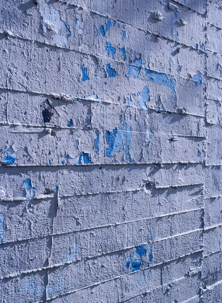 cement wall with lines. Painted and chipped by the passage of time. Exterior texture.