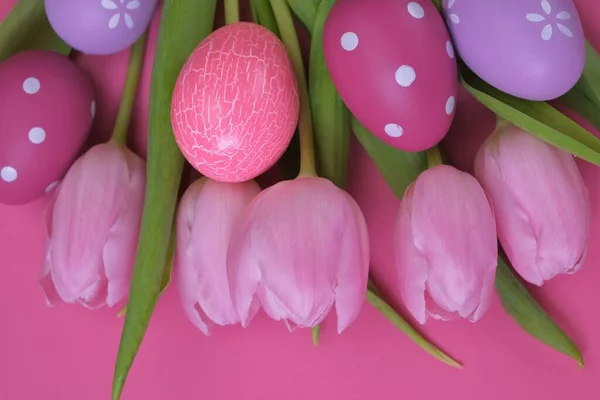 Easter holiday.pink tulips flowers, purple and pink easter eggs set.Easter eggs and spring flowers set.Spring festive easter background.Spring religious holiday