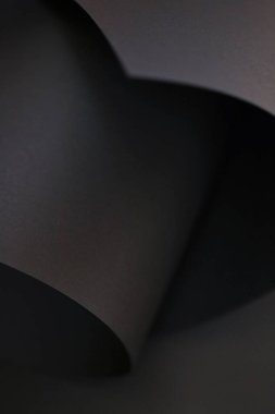 Siyah soyut arka plan. Siyah kağıt dokusu. Siyah renkli dalga ve kıvrımlar. Duvar kağıdı fon.Kopya alanı. Soyut lüks bulanık arkaplan 