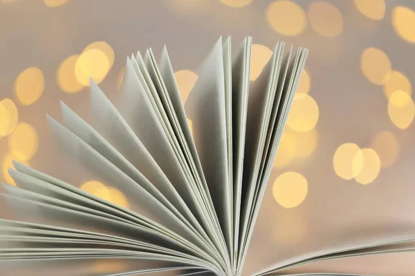 Book pages close-up on shining bokeh background.Winter books. Christmas books.Winter cozy reading.Book of fairy tales.Reading books.