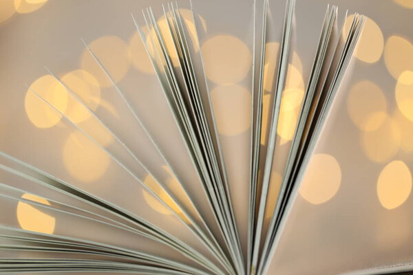 Reading books. Book pages close-up on shining bokeh background.Winter books. Christmas books.Winter cozy reading.Book of fairy tales. High quality photo