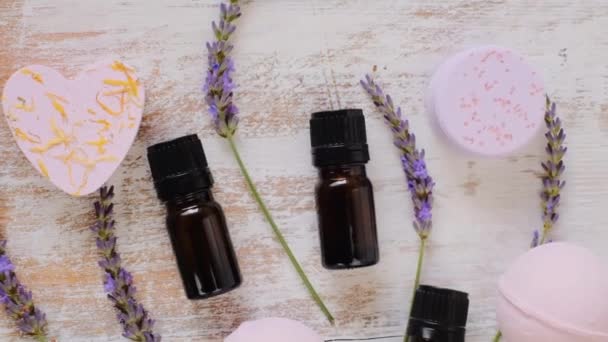 Lavender oil and bath bombs, lavender flowers on vintage shabby background — Stock Video