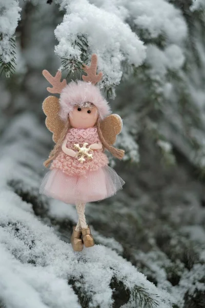 Winter angel on a snowy tree. Snow fairy.Christmas and New Years . Christmas symbol.Christmas tree toy. — Stock Photo, Image