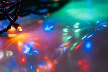 Macro Shot of Christmas String Lights. Garland lights and multicolored bokeh . Christmas Lights with Bokeh Effect.Tangled String of Christmas Lights
