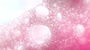 Yumuşak pembe sabun köpüğü deseni. Pembe baloncuklu bir arka plan. Pembe köpük makro arka plan. 4k görüntü