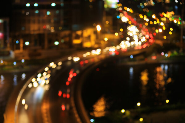 Abstract festive curves of bridges background with bokeh defocused lights of downtown of Ho Chi Minh City ( Sai Gon ) , Vietnam from high view at in sunset or sunrise