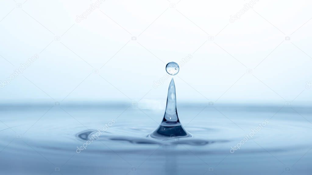 water drop splash in a glass blue colored