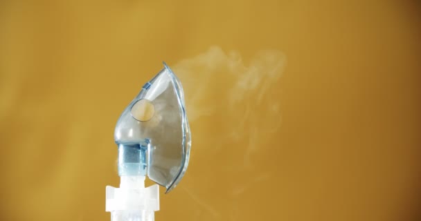 Nebulizer machine for cough medicine in orange backgraund — Stock Video