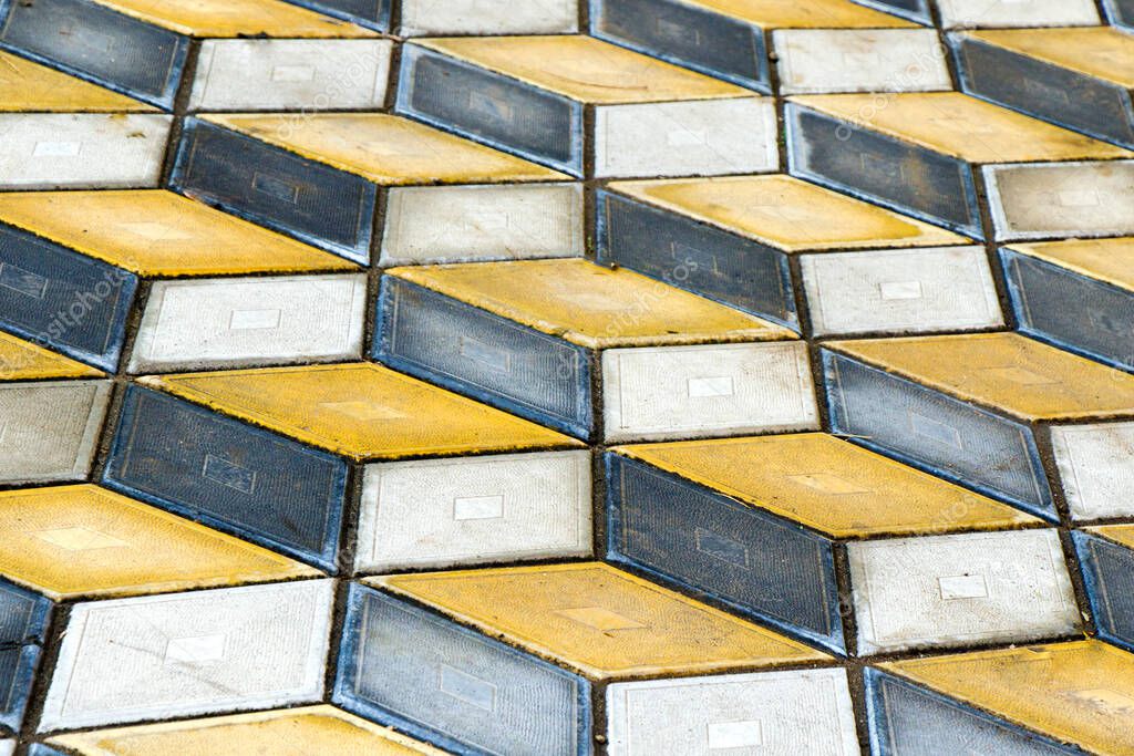Geometry cubes optical illusion floor in the park of Tbilisi. Geometry figure background. Yellow and black.