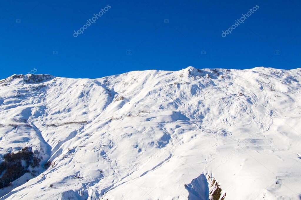 Snowy mountains landscape in Gudauri, Georgia. Sunny day.