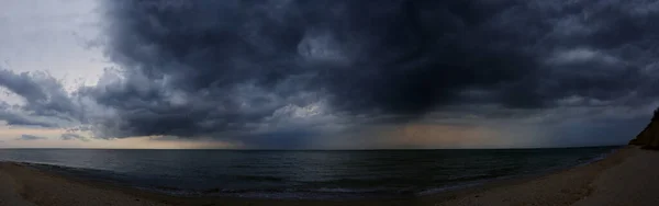 Storm dark clouds over sea water in summer