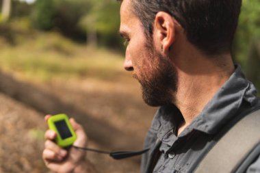 Dağda yürüyüş yapan ve GPS 'i izleyen bir çocuk. Spor kavramı. Doğa. Açık havada..