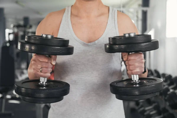 Man holding dumbbells.health and well-being concept.