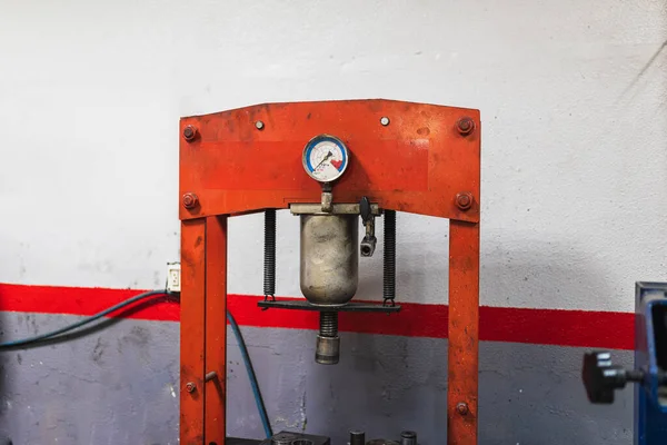 Pressing machine in car workshop.