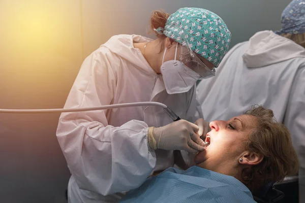 Dental patient having their teeth cleaned and polished by the hygienist. Dental health concept