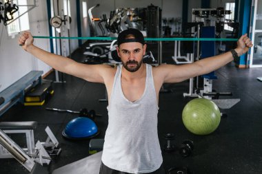 Lastik bantla egzersiz yapan bir adam..