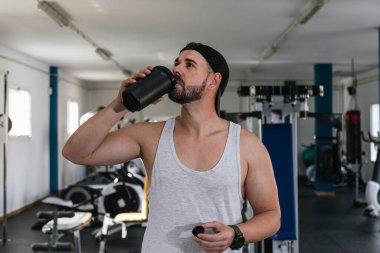 Erkek sporcu protein içeceği içiyor.