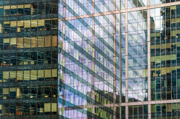 Office windows, reflections and shadows on glass exterior of business center building in Moscow city, Moscow 28.06.2020