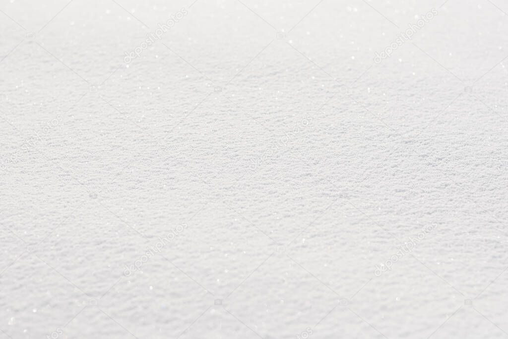 Full frame background of fresh white snow, photo with shallow depth of field