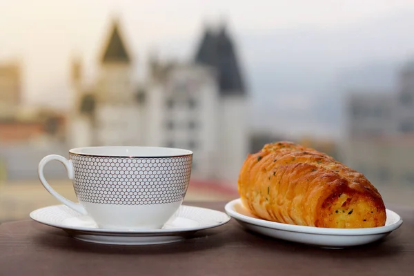 Kahve fincanı ve lüks otel geçmişi olan kahvaltı pastası.