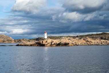 İsveç Atlantik kıyısındaki bir balıkçı köyünün dışında güzel bir deniz feneri. Fotoğraf: Hamburgsund, Vastra Gotaland, İsveç