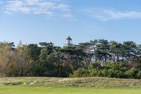 A brick lighthouse with a bright blue sky in the background. Picture of Falsterbo Lighthouse from 1796 in Scania, southern Sweden