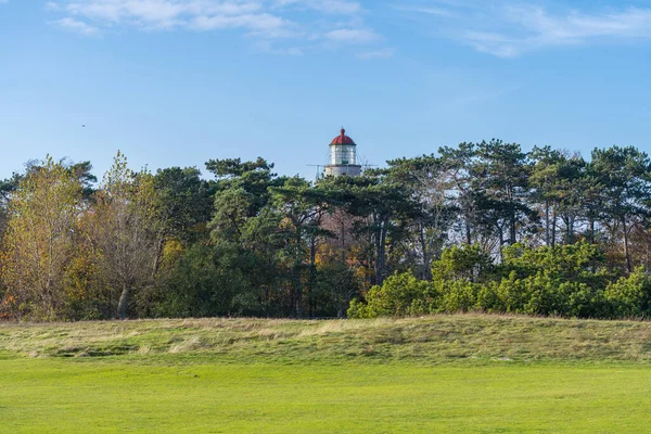 A brick lighthouse with a bright blue sky in the background. Picture of Falsterbo Lighthouse from 1796 in Scania, southern Sweden