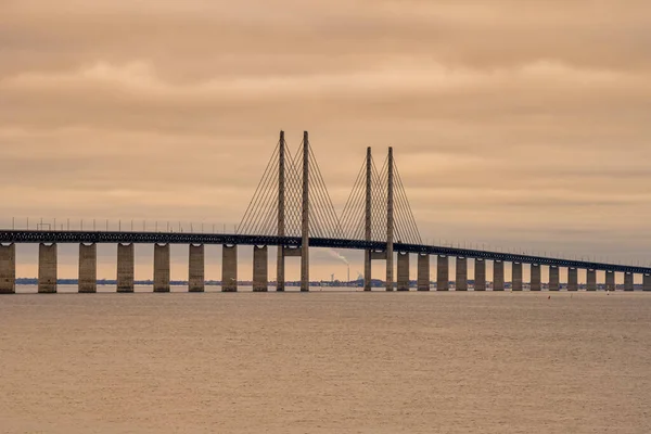 The Oresund Bridge, the bridge and underwater tunnel connecting Malmo, Sweden with Copenhagen, Denmark. A beautiful sunset sky in the background