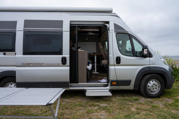 A camper van in parked by the ocean