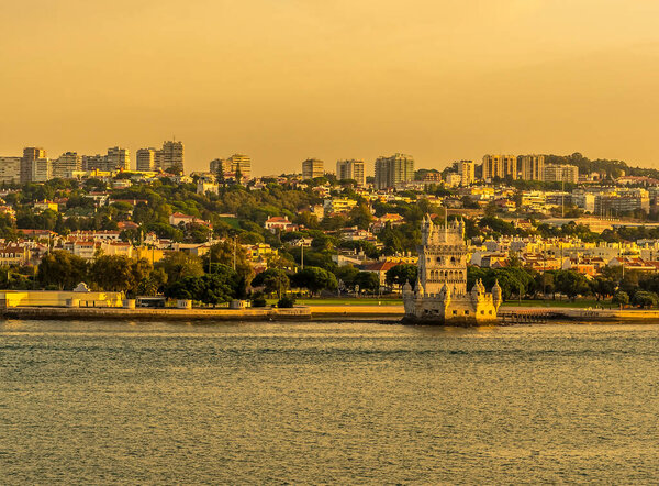 A view from the river Tagus of the Belem district of Lisbon, Portugal in the golden early morning light at sunrise in Autumn