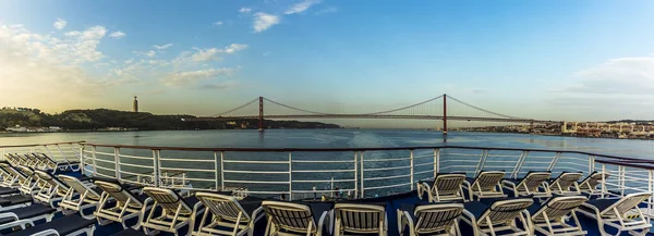 Cruising up the Tagus river, Lisbon, Portugal at first light passing underneath the suspension bridge named after the 25th April revolution