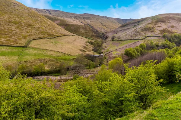 A view across a river valley towards the river source in the Dark Peak in Derbyshire, UK