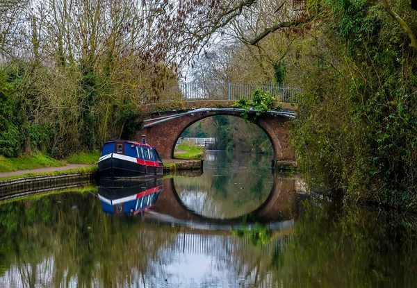 Reflections in the mirror surface of  the Grand Union Canal near Foxton Locks, UK on a still winter\'s afternoon